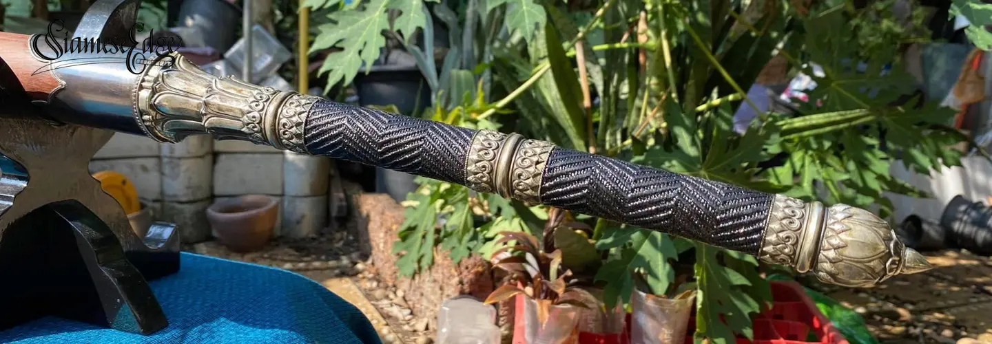 Braided grip with natural lacquer and cast lotus fittings.