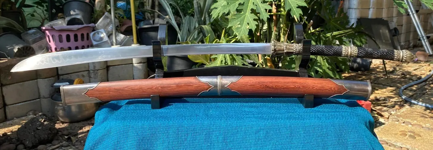 A custom Ayuthaya-style dhaab with silver fittings on the scabbard.