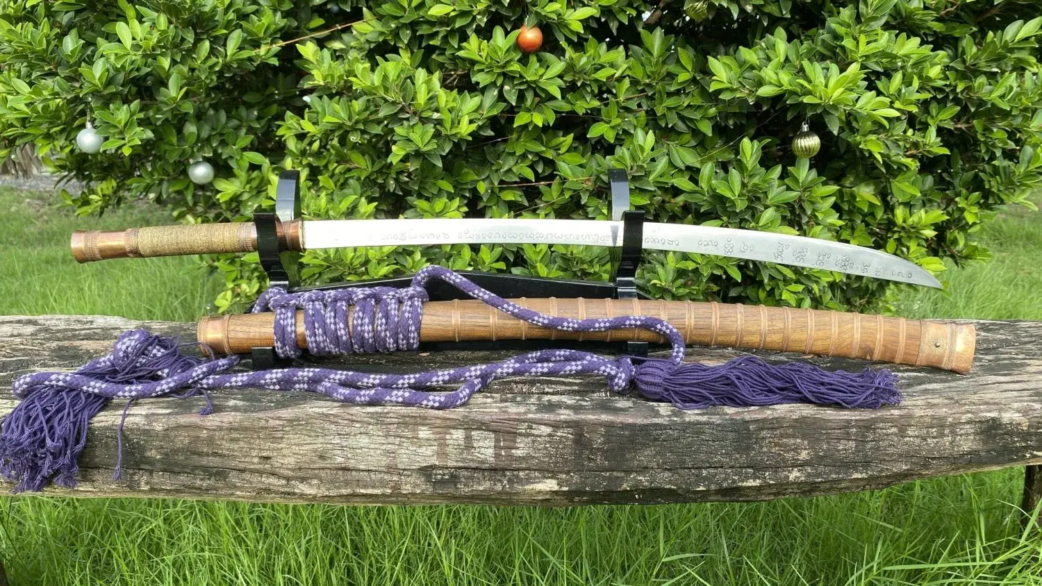 Custom build outdoors: engraved blade, tan-wrapped handle and matching wrapped scabbard, purple and white hand-woven rope