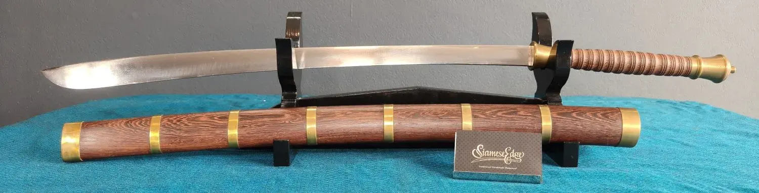 Panoramic crop of the sword above its scabbard on the stand
