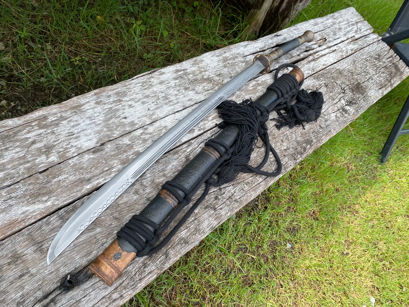 Sword and scabbard laid on the plank
