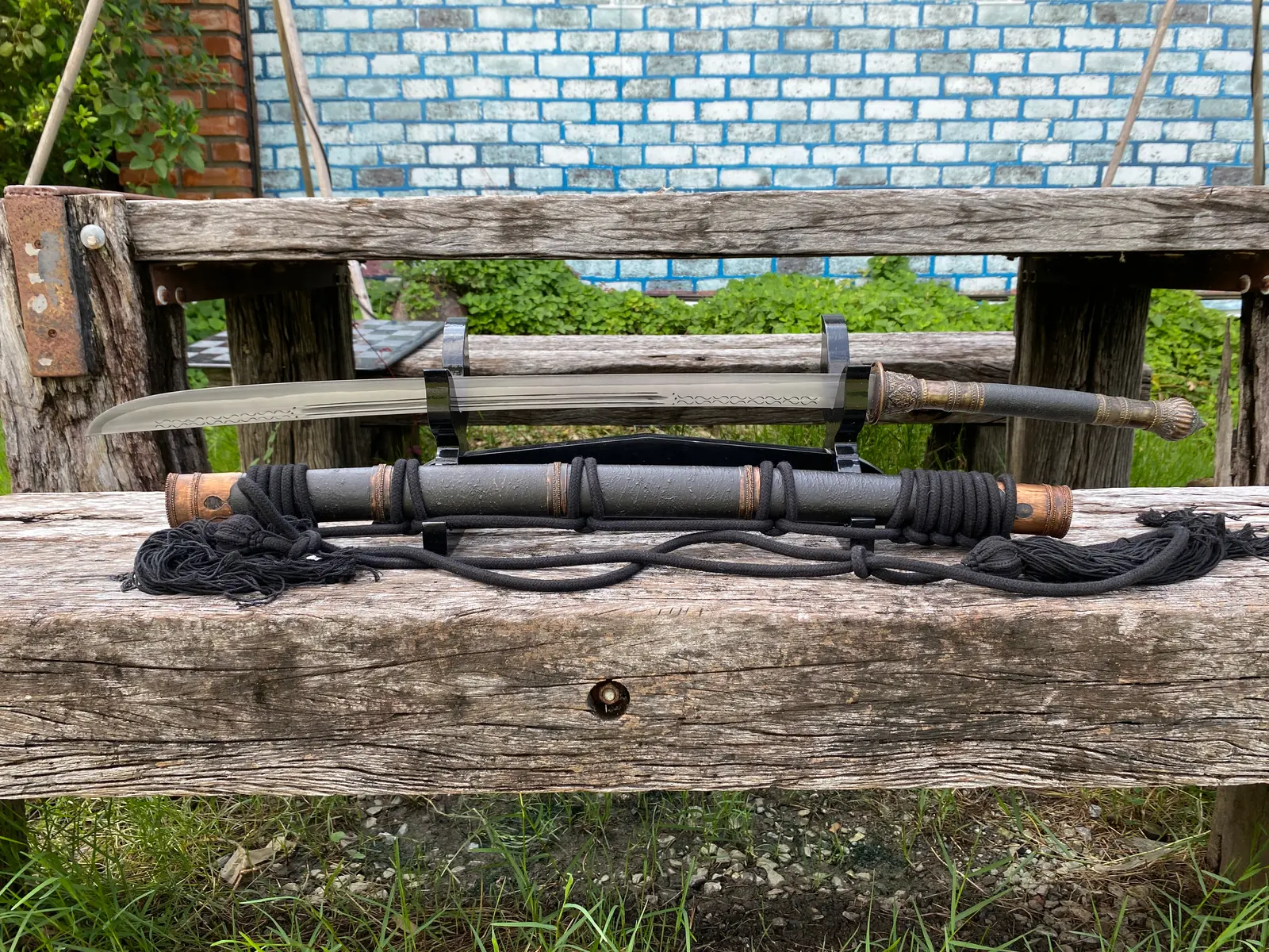 Straight side view of the whole sword above its scabbard