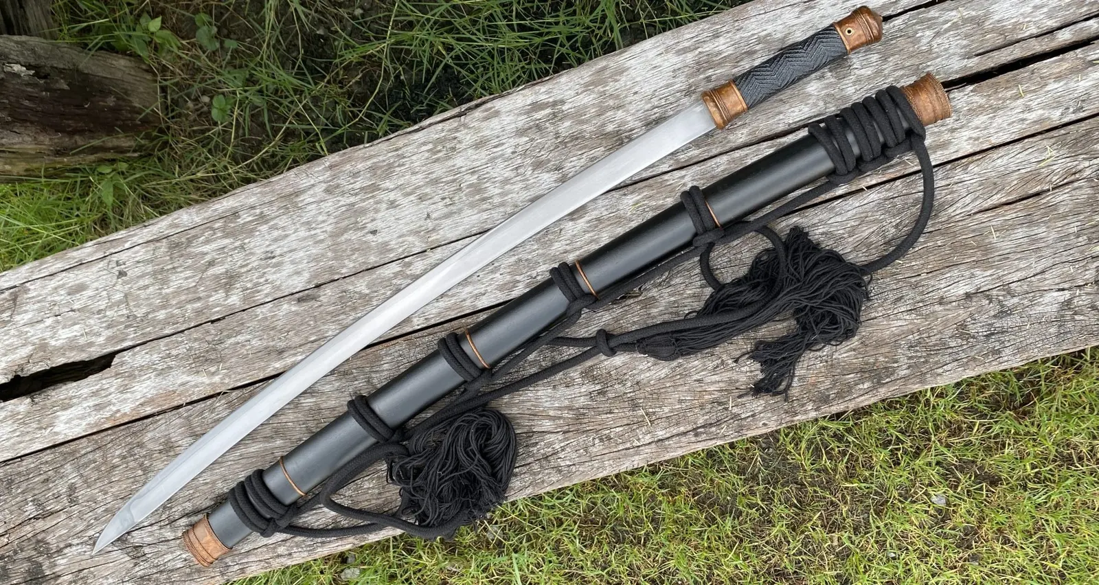 The sword and scabbard with carry rope, landscape view.