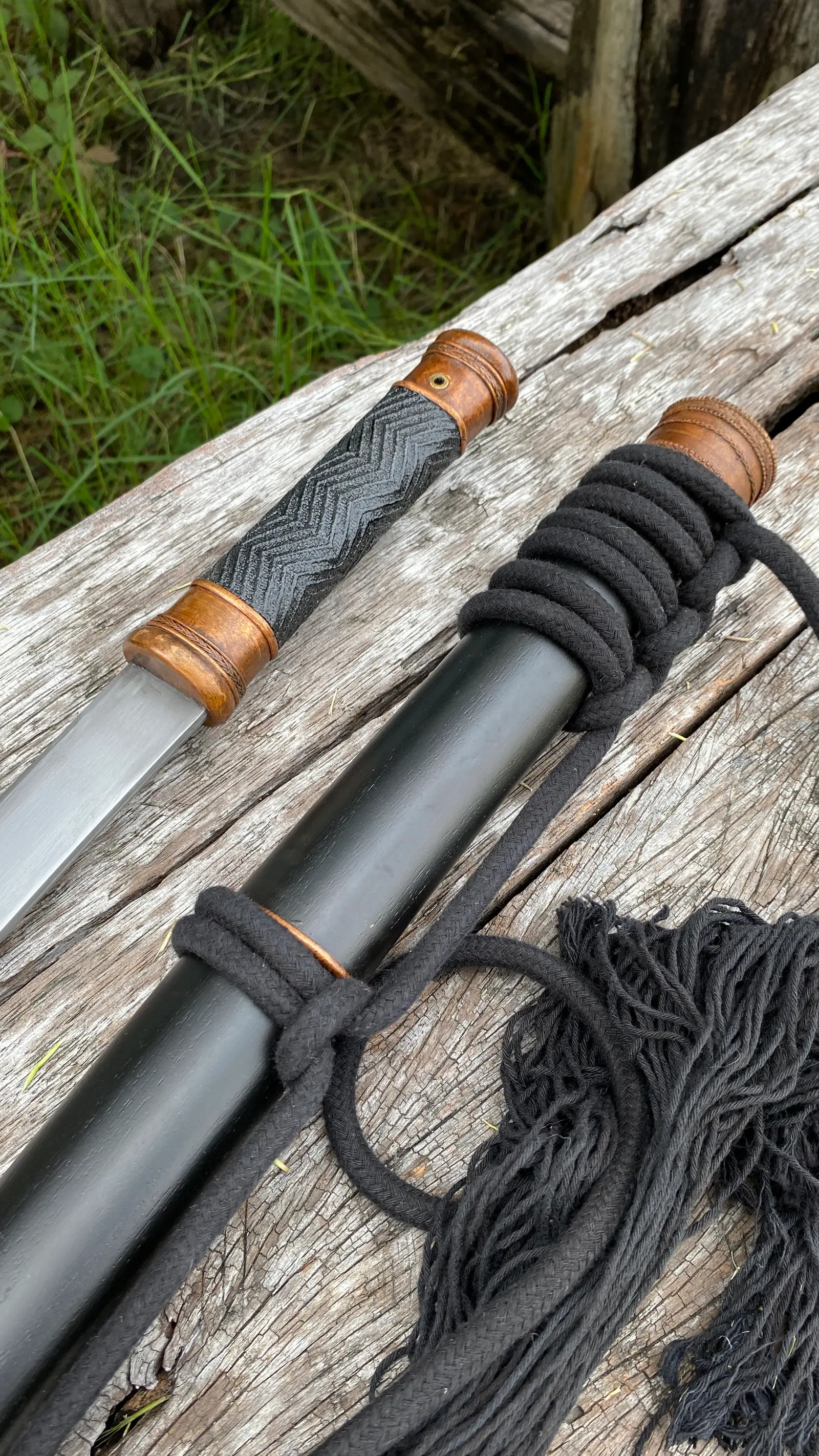 Close-up of the handle and the scabbard mouth with the rope binding.