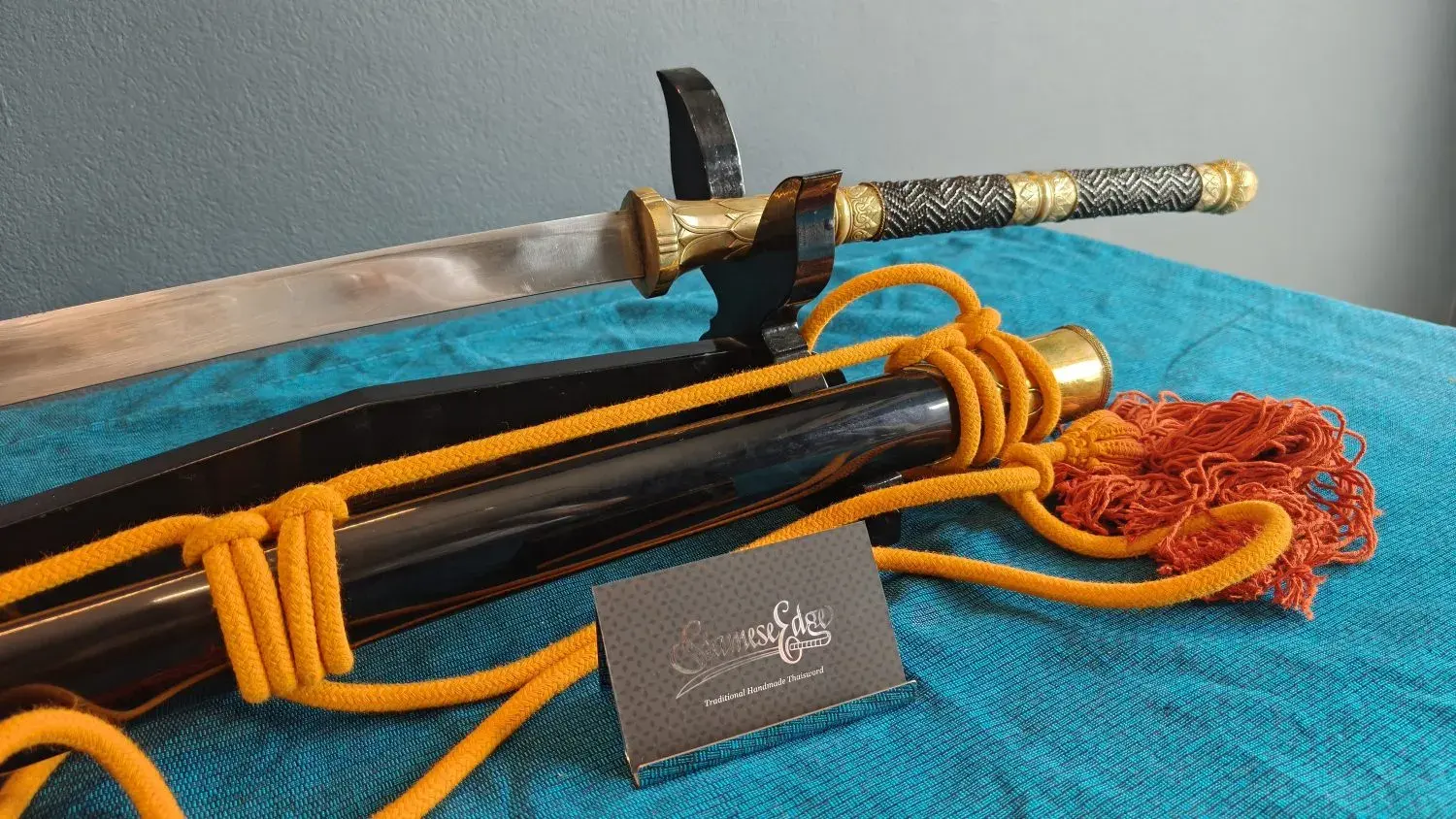 Handle and scabbard mouth with the rope wrapped round the scabbard.