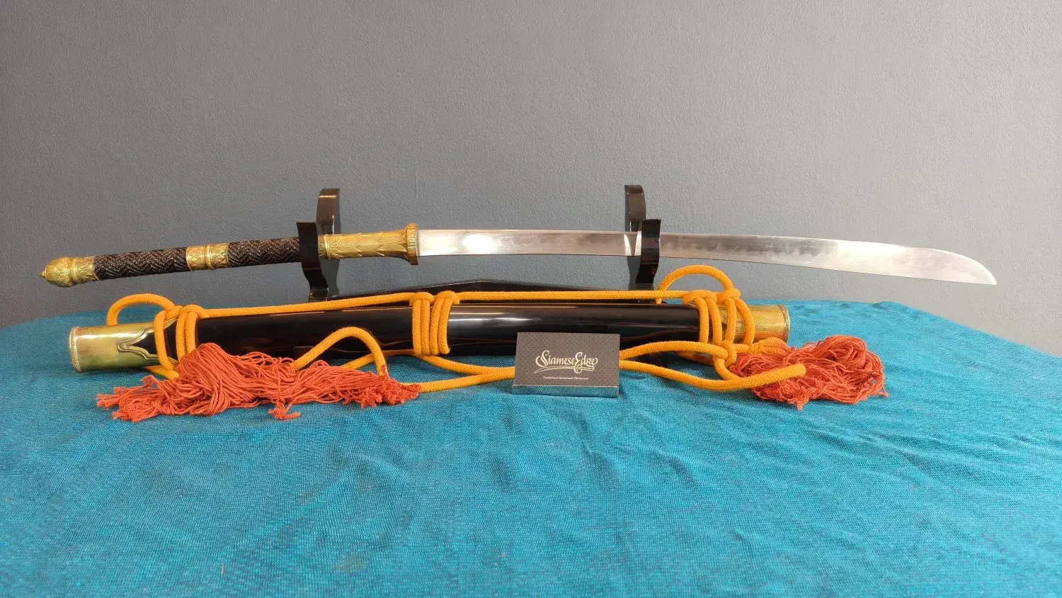 Full side view, reversed, with the brass lotus collar and the black scabbard.