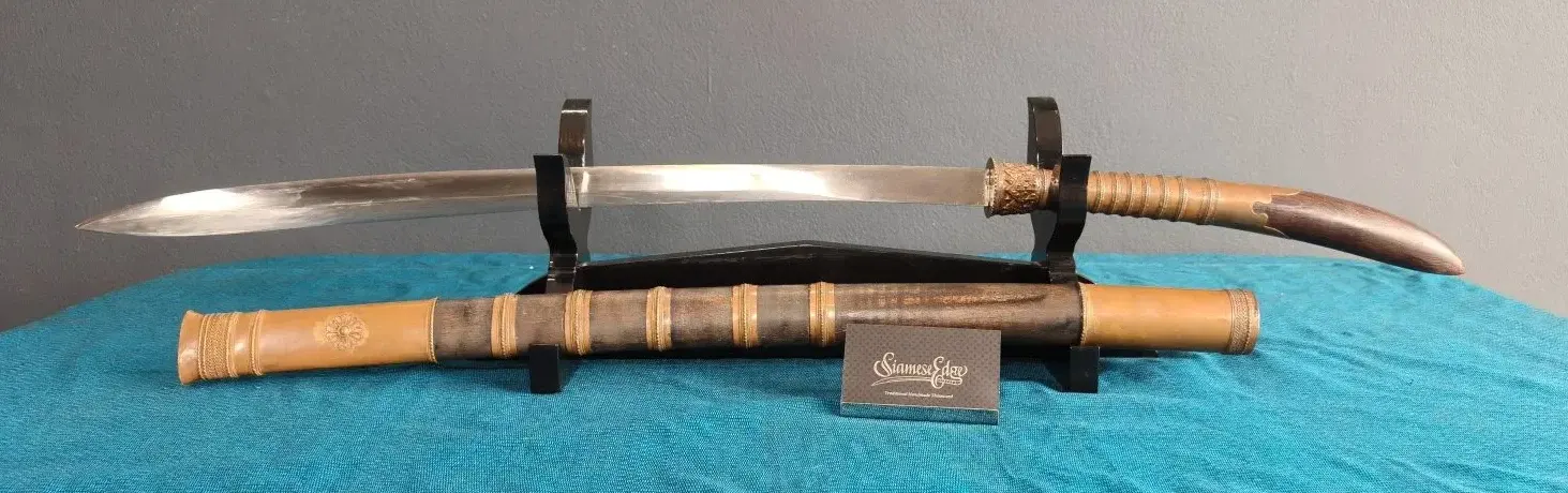 The sword on its stand above the scabbard, in a wide crop.