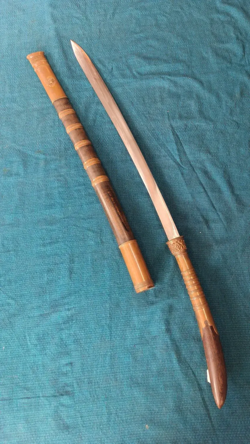 Overhead: scabbard and drawn sword on the diagonal.