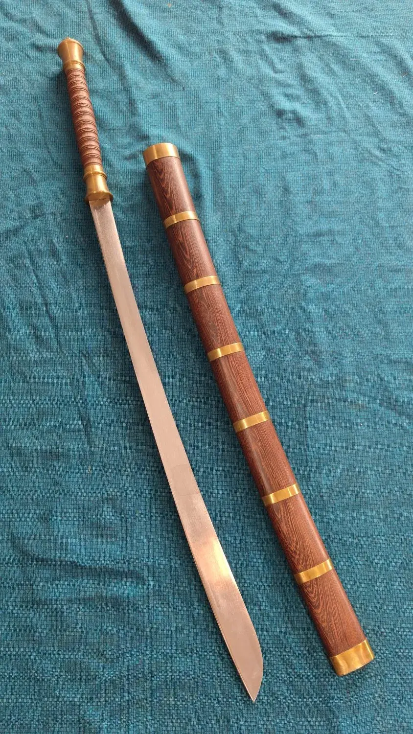 Overhead view of the Dhaab Dang drawn beside its banded rosewood scabbard on teal cloth