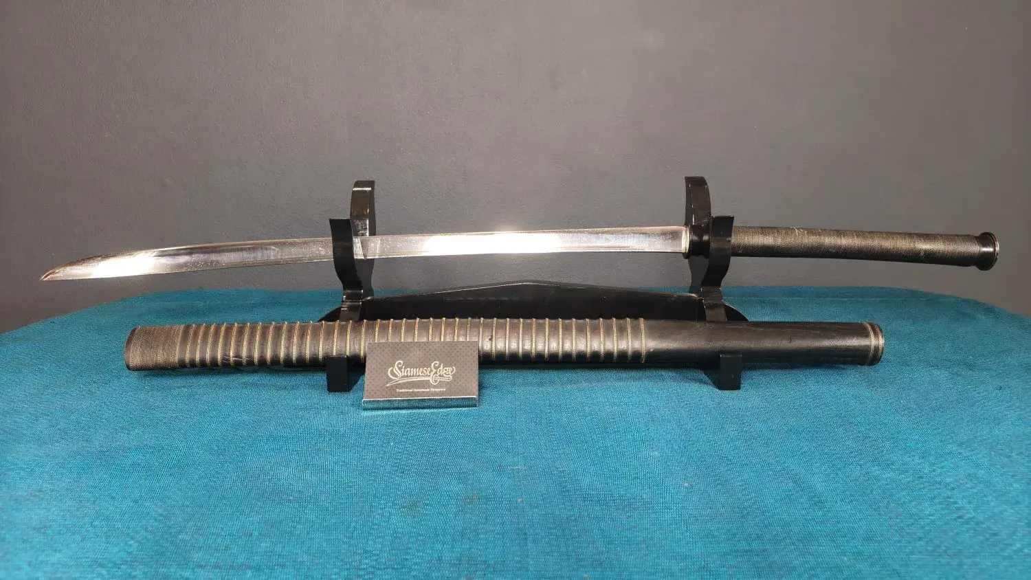 EcoLine Thai–Laos on a two-post stand above its scabbard