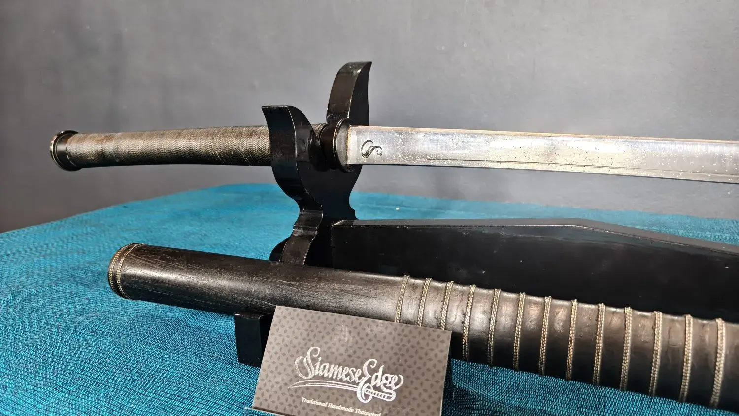 EcoLine handle close-up: black cord-wrapped grip, blackened ferrule and cap